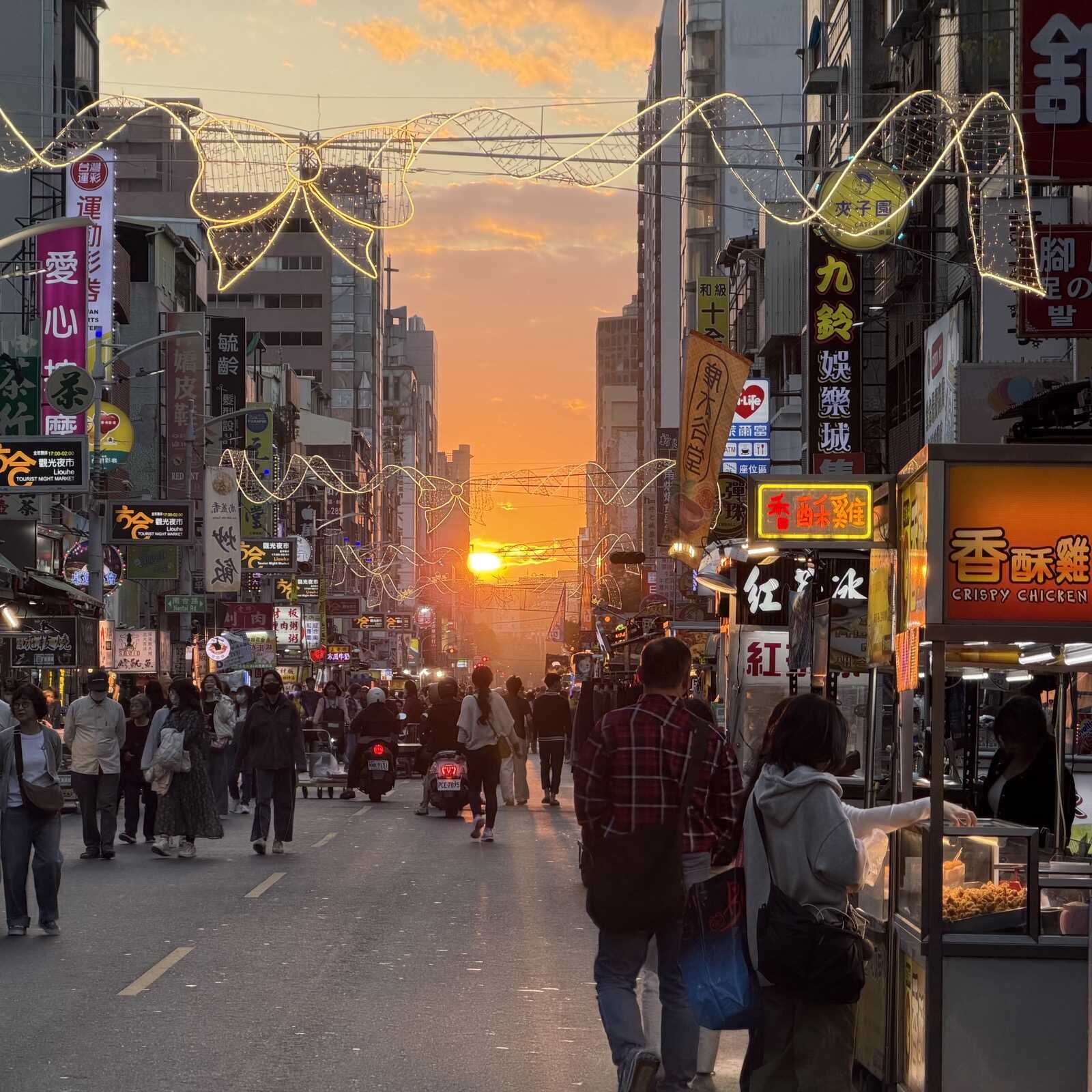 Looking at a sunset along a street market